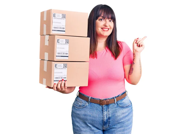 Young Size Woman Holding Delivery Package Smiling Happy Pointing Hand — Stock Photo, Image