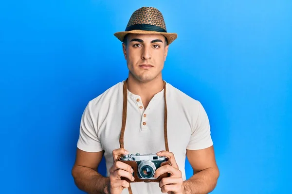 Hispanic Young Man Holding Vintage Camera Relaxed Serious Expression Face — Stock Photo, Image