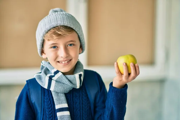 Sevimli Sarışın Öğrenci Gülümseyerek Okulda Yeşil Elma Tutuyor — Stok fotoğraf