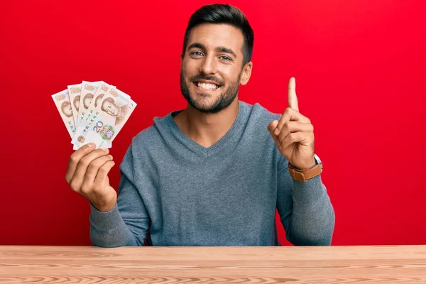 Handsome Hispanic Man Holding Yuan Chinese Banknotes Smiling Idea Question — Stock Photo, Image