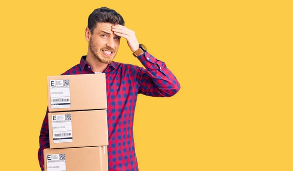 Handsome Young Man Bear Holding Delivery Packages Stressed Frustrated Hand — Stock Photo, Image