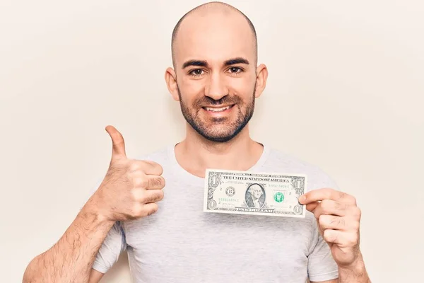 Jovem Careca Bonito Segurando Uma Nota Dólar Sorrindo Feliz Positivo — Fotografia de Stock