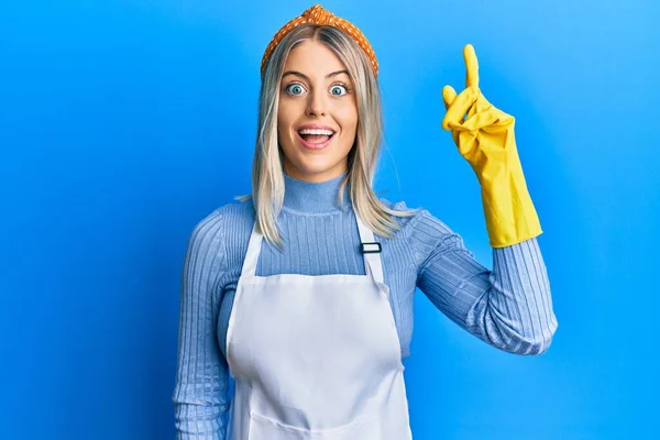 Beautiful Blonde Woman Wearing Cleaner Apron Gloves Pointing Finger Successful — Stock Photo, Image