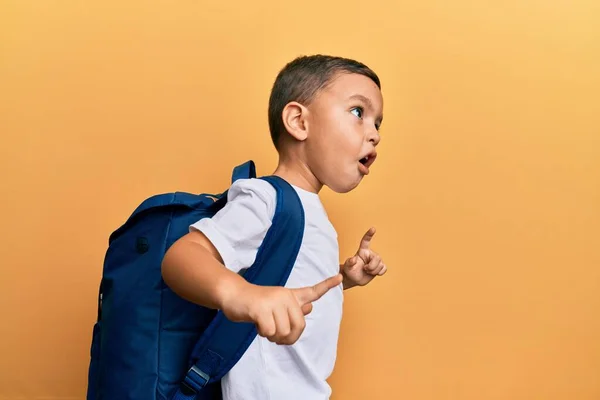 愛らしいラテン幼児笑顔幸せな身に着けている学生バックパック上の隔離された黄色の背景 — ストック写真