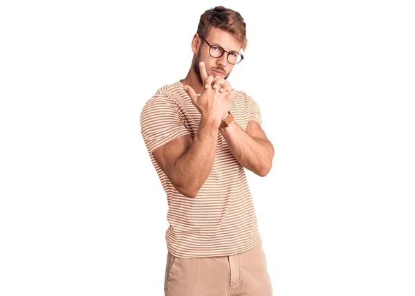 Young Caucasian Man Wearing Casual Clothes Glasses Holding Symbolic Gun — Stock Photo, Image