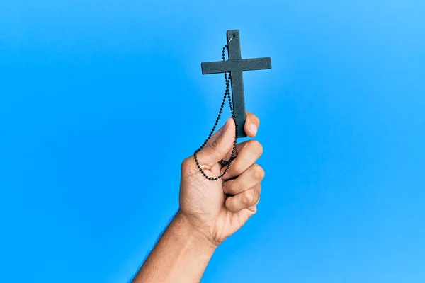 Mano Uomo Ispanico Che Tiene Croce Cristiana Isolato Sfondo Blu — Foto Stock
