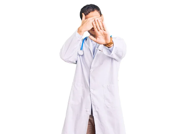 Handsome Young Man Bear Wearing Doctor Uniform Covering Eyes Hands — Stock Photo, Image