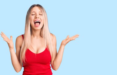 Genç ve güzel sarışın kadın, gündelik giysiler giyip başarının çılgınlığını kutluyor. Kollarını kaldırmış, gözlerini kapatmış heyecanlı çığlıklar atıyordu. Kazanan konsept 