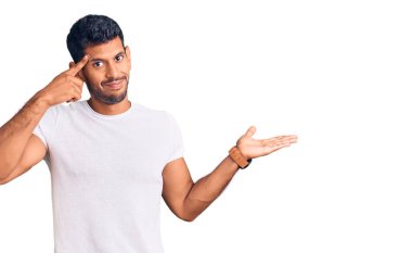 Gündelik kıyafetler giyen genç latin adam avuç içi açık fotokopi alanı ve parmak alnını göstermekten rahatsız oluyor. Bunu bir düşün.. 