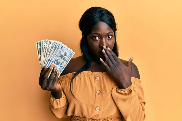 African Young Woman Holding Dollars Covering Mouth Hand Shocked Afraid — Φωτογραφία Αρχείου
