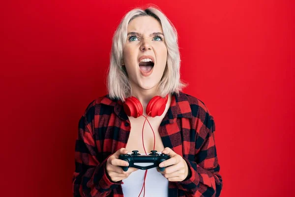 Young Blonde Girl Playing Video Game Holding Controller Angry Mad — Stockfoto