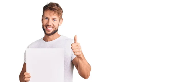 Young Caucasian Man Holding Blank Empty Banner Smiling Happy Positive — Fotografia de Stock