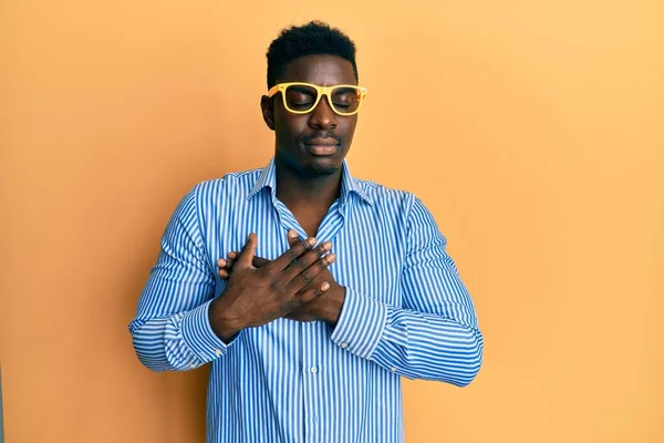 Handsome Black Man Wearing Yellow Glasses Smiling Hands Chest Eyes — Φωτογραφία Αρχείου