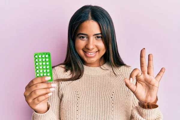 Young Latin Girl Holding Birth Control Pills Doing Sign Fingers — 스톡 사진