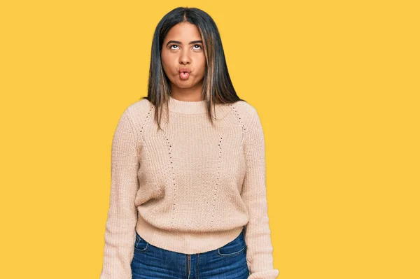 Young Latin Girl Wearing Wool Winter Sweater Making Fish Face — Zdjęcie stockowe