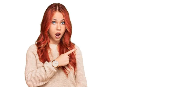 Young Redhead Woman Wearing Casual Winter Sweater Surprised Pointing Finger — Stock Photo, Image