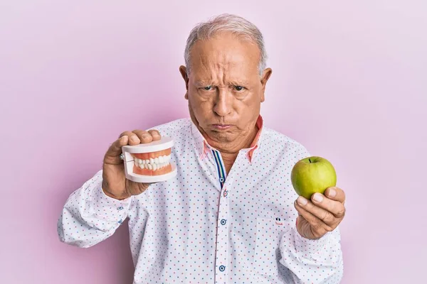 Senior Caucasian Man Holding Denture Green Apple Depressed Worry Distress — Stock Photo, Image