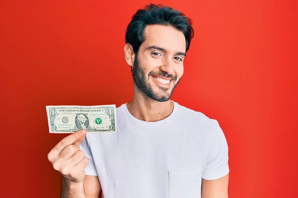 Young Hispanic Man Holding Dollar Banknote Looking Positive Happy Standing — Stock Photo, Image