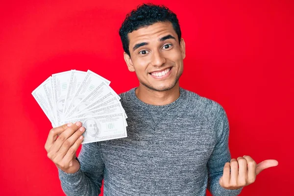 Joven Hombre Hispano Guapo Sosteniendo Bolsa Dinero Con Símbolo Del —  Fotos de Stock