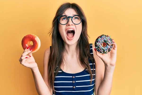 Young Beautiful Caucasian Girl Holding Tasty Colorful Doughnuts Angry Mad — Stockfoto