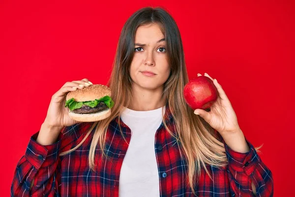 Bella Donna Caucasica Confrontando Hamburger Mela Rossa Sana Scettico Nervoso — Foto Stock