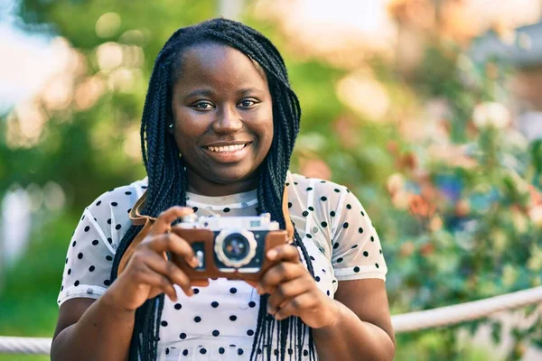年轻的非洲裔美国女游客在城里用老式相机开心地微笑着 — 图库照片
