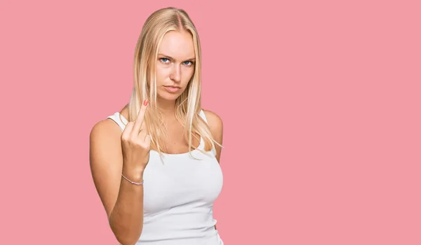 Young Blonde Girl Wearing Casual Style Sleeveless Shirt Showing Middle — Zdjęcie stockowe