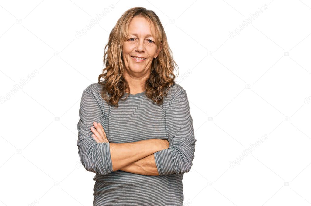 Middle age blonde woman wearing casual clothes happy face smiling with crossed arms looking at the camera. positive person. 