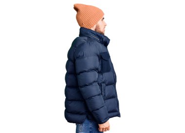 Kışlık giysiler giyen yakışıklı bir genç, rahat bir görünüm takınıyor, doğal bir yüz ifadesi ve kendine güvenen bir gülümsemesi var.. 