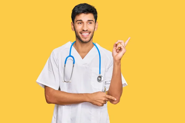 Young Handsome Man Wearing Doctor Uniform Stethoscope Smiling Happy Pointing — Stock Photo, Image