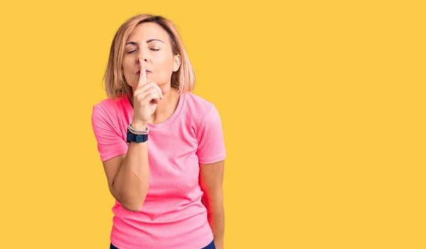 Young Blonde Woman Wearing Sportswear Asking Quiet Finger Lips Silence — Stock Photo, Image