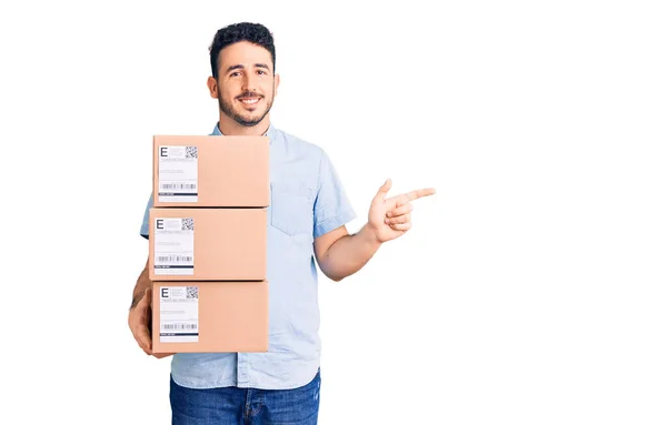 Young Hispanic Man Holding Delivery Package Smiling Happy Pointing Hand — Stock Photo, Image