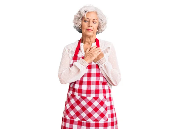 Senior Grey Haired Woman Wearing Apron Smiling Hands Chest Closed — Stock Photo, Image