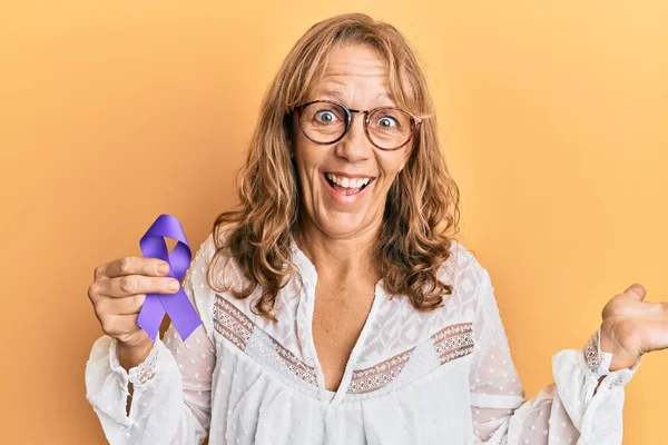 Middle Age Blonde Woman Holding Purple Ribbon Awareness Celebrating Achievement — Stock Photo, Image