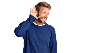 Sakallı, sıradan süveter giyen, ağzı kulaklarına varan dedikoduları ve dedikoduları dinleyen yakışıklı sarışın adam. Sağırlık kavramı. 