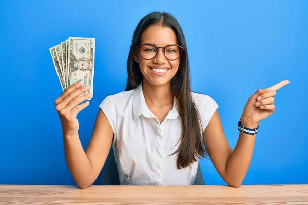 Beautiful Hispanic Woman Holding Dollars Banknotes Smiling Happy Pointing Hand — Stock Photo, Image