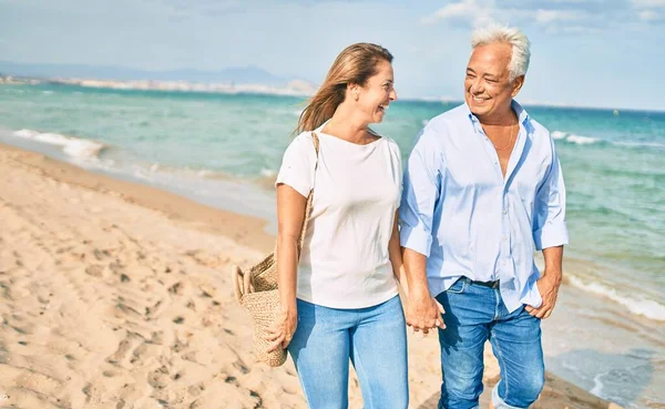 Pareja Hispana Mediana Edad Sonriendo Feliz Caminando Playa —  Fotos de Stock