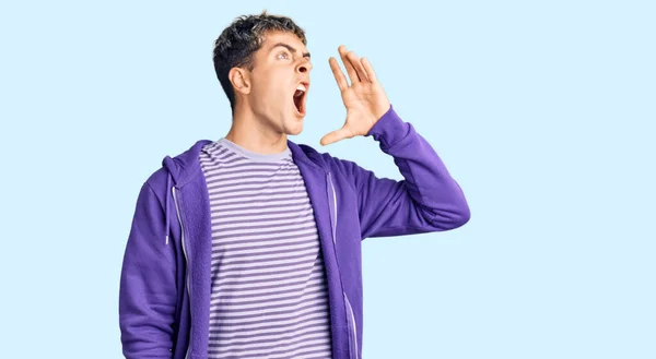 Young Handsome Man Wearing Casual Purple Sweatshirt Shouting Screaming Loud — Stock Photo, Image