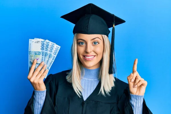 Beautiful Blonde Woman Wearing Graduation Cap Ceremony Robe Holding Hungarian — Stock Photo, Image