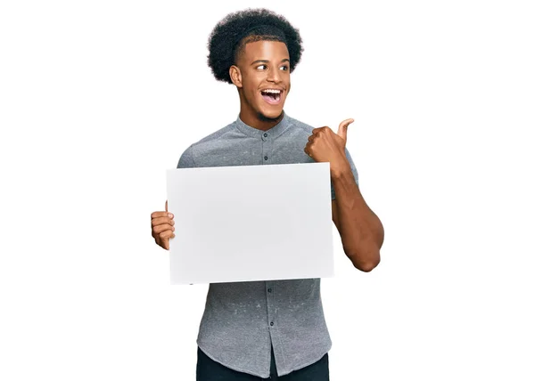 African American Man Afro Hair Holding Blank Empty Banner Pointing — Stock Photo, Image
