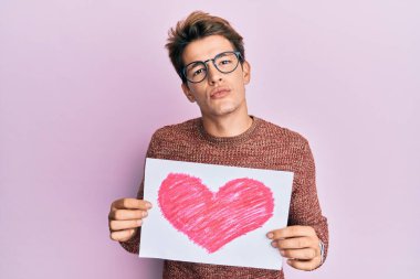 Yakışıklı, beyaz, kalbi olan bir adam kameraya bakıp öpüşüyor ve güzel ve seksi oluyor. aşk ifadesi. 