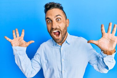 Yakışıklı, sakallı, sıradan kıyafetler giyen çılgın kutlamalar yapan ve başarıya hayran olan kolları açık, gözleri açık heyecanlı bir adam. Kazanan konsept 