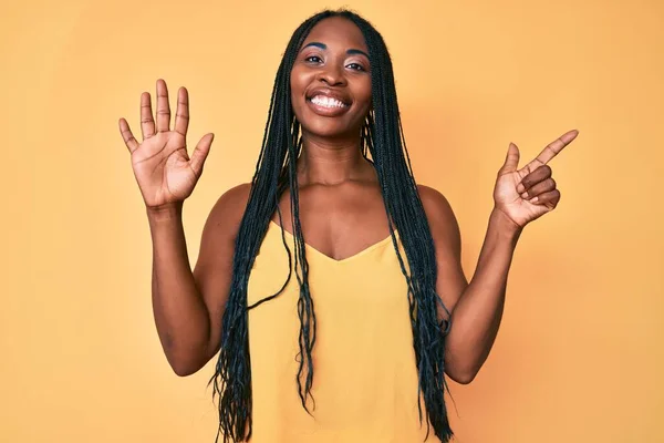 Afroamerykanka Warkoczami Luźnych Ubraniach Pokazująca Wskazująca Palcami Numer Siedem Uśmiechnięta — Zdjęcie stockowe