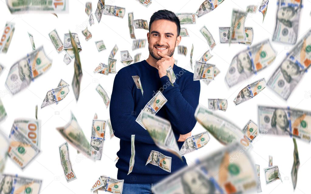 Young handsome man wearing casual clothes looking confident at the camera with smile with crossed arms and hand raised on chin. thinking positive.