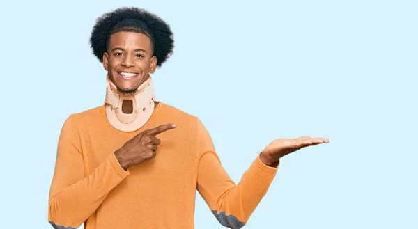 African American Man Afro Hair Wearing Cervical Neck Collar Amazed — Stock Photo, Image