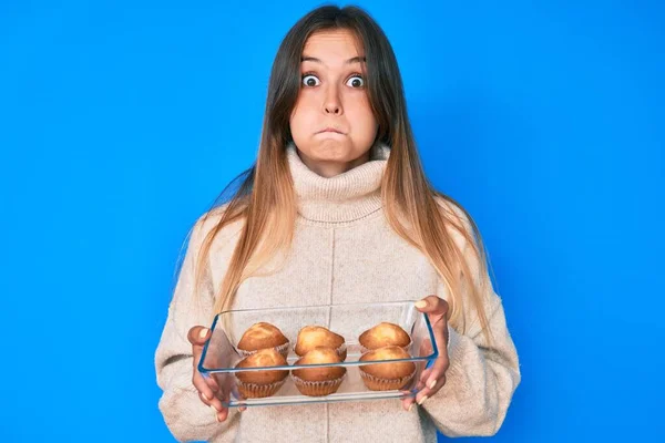 Beautiful Caucasian Woman Holding Homemade Muffins Puffing Cheeks Funny Face — Stock Photo, Image