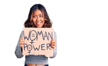 Genç, güzel, melez bir kadın elinde bayrak tutuyor. Olumlu ve mutlu görünüyor. Kendine güvenen bir gülümsemeyle dişlerini gösteriyor. 