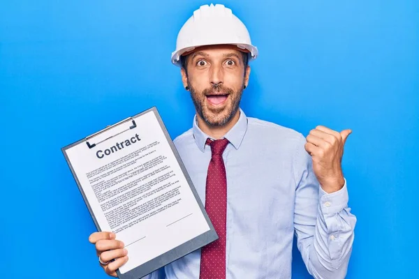 Young Handsome Man Wearing Architect Hardhat Holding Contract Document Pointing — 图库照片
