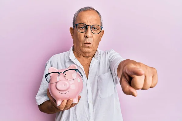 Handsome Mature Senior Man Holding Piggy Bank Glasses Pointing Finger — Stock Photo, Image