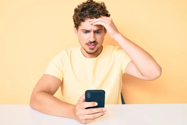 Young Caucasian Man Curly Hair Using Smartphone Sitting Table Stressed — Stock Photo, Image